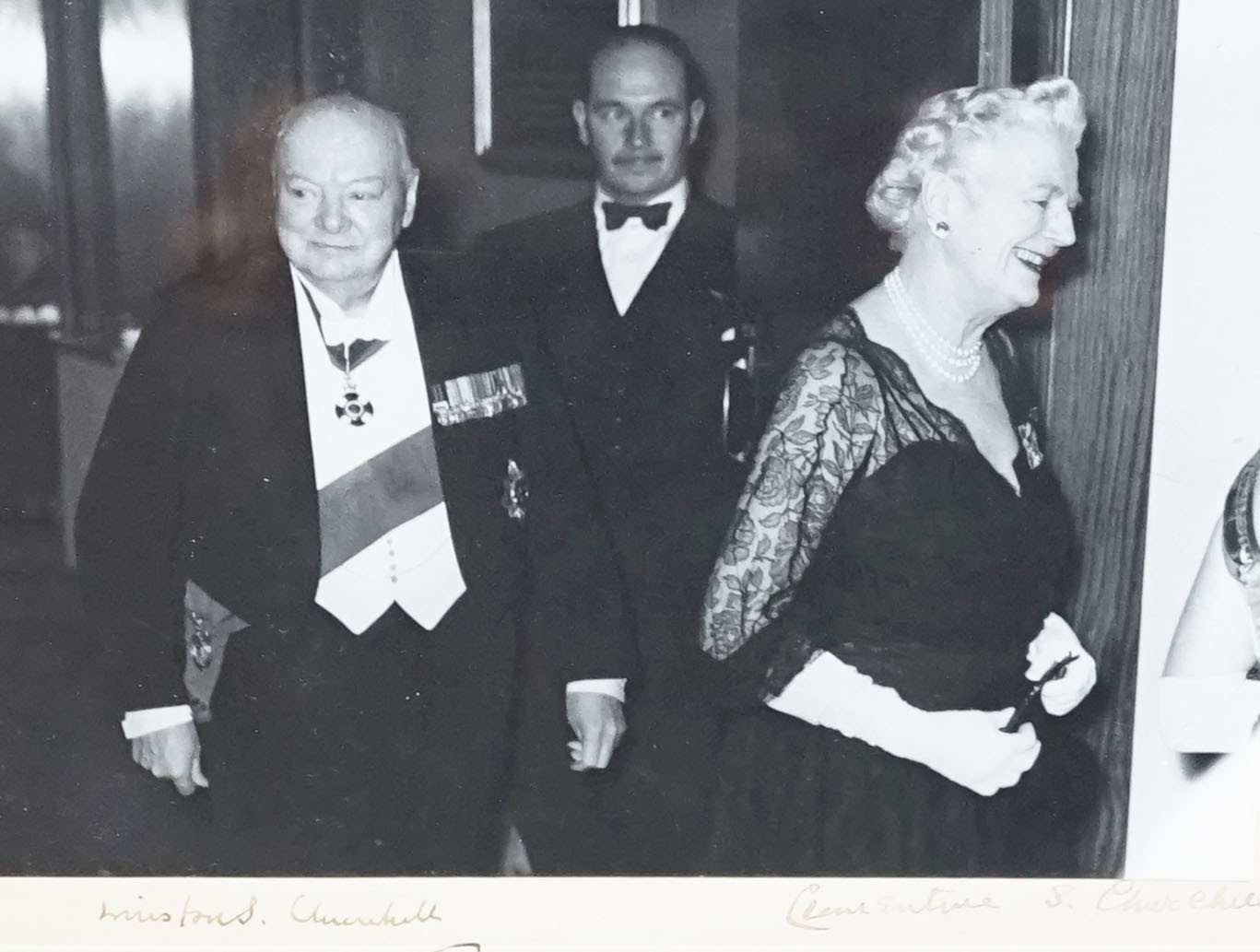 A signed photograph of Sir Winston Churchill and his wife Clementine taken 20th April 1956 at The St James Hawkey Hall, Woodford Green. Overall 17.5 x 22.5 cm